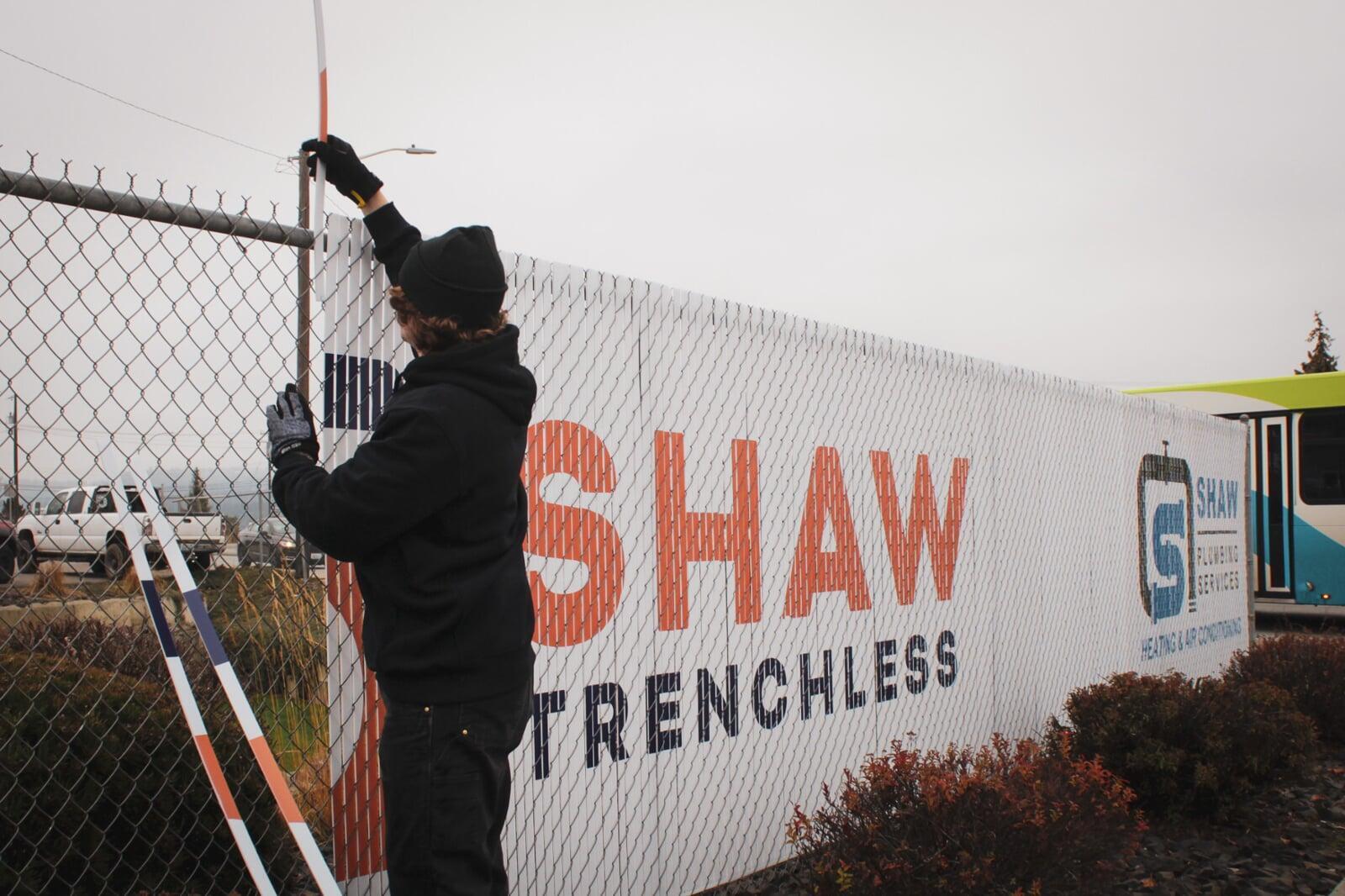 Close up example of custom printed fence slats installed on chain link fence